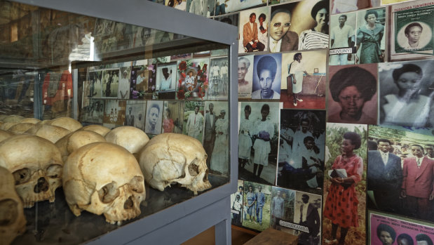 Skulls of some of those who were slaughtered as they sought refuge in the Catholic Church in Ntarama, Rwanda, are placed in a glass case next to photographs of some of them, kept as a memorial to the thousands who were killed in and around the church during the 1994 genocide.