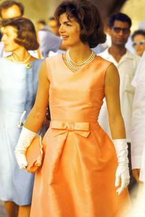 Jackie Kennedy Onassis often wore white gloves and pearls on official visits.
