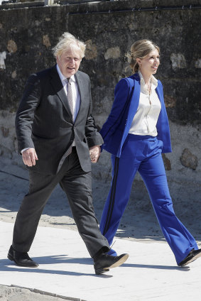 PM Boris Johnson and his wife Carrie Johnson walk along the boardwalk during an official welcome of guests at the G7 summit in Carbis Bay, Cornwall in June 2021. 