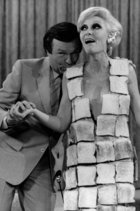 Jeanne Little with Mike Walsh in a dress made of toast.