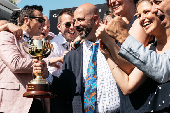 Ozzie Kheir holds the 2021 Melbourne Cup after Verry Elleegant’s victory.