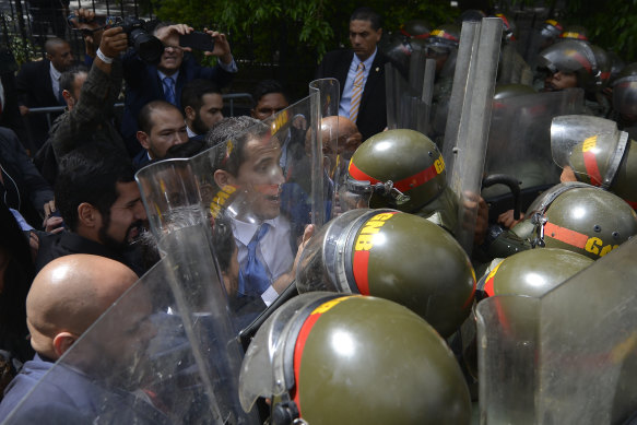 Guaido and his allies are blocked from entering parliament by National Guard troops with riot shields.