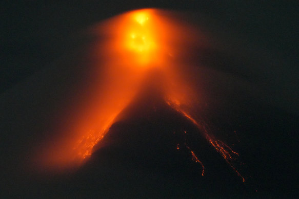 Mayon volcano belches red-hot emissions down its slope as seen from Legaspi, Albay province, north-eastern Philippines on Sunday.