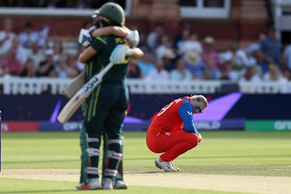 While Australian cricketers celebrate, Sophie Ecclestone looks sad.