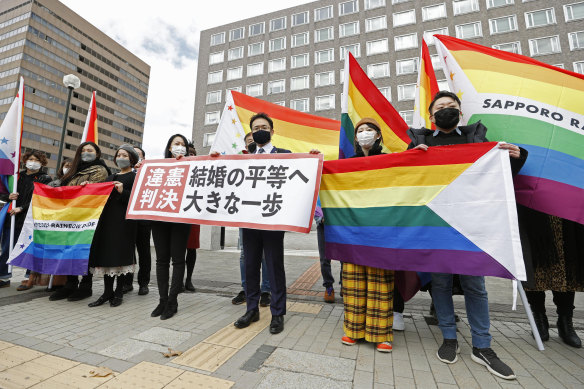 Supporters of same-sex marriage outside Sapporo District Court on Wednesday. The banner reads: “Unconstitutional judgment.”