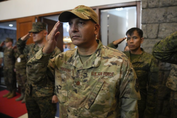 A member of the US Air Force salutes beside Filipino troopers ahead of joint military exercises last month.