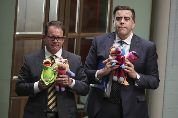 Luke Gosling and Milton Dick leave the chamber under 94a after they brought Muppets into question time.