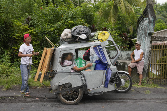 Residents living near the Mayon volcano prepare to move to an evacuation centre on Sunday.