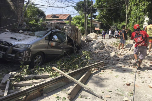 A wall collapsed on this car in Ilocos Sur Province, Philippines, on Wednesday.