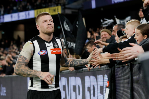 Jordan De Goey celebrates with Magpies fans.