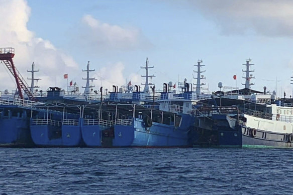 In this photo provided by the National Task Force-West Philippine Sea, Chinese vessels are moored at Whitsun Reef, South China Sea on March 27, 2021. 