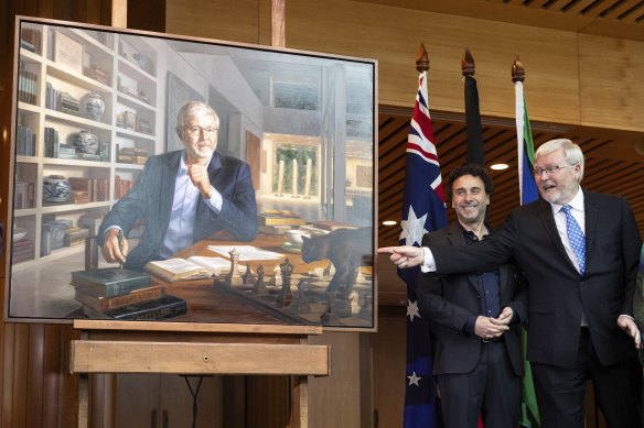 Kevin Rudd during the unveiling of his official portrait by Ralph Heimans (left), at Parliament House in Canberra. 