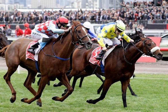 Christophe Lemaire (yellow and blue silks) wins the 2011 Melbourne Cup on Dunaden.