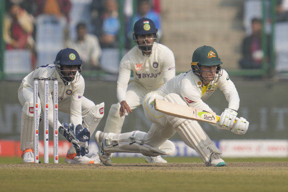 Alex Carey plays a sweep shot on day three in Delhi.