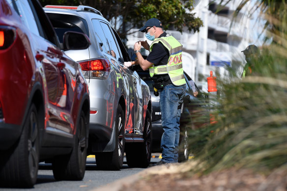 Police check the details of motorists crossing at a Coolangatta border checkpoint last month.