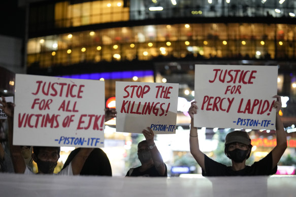 Activists hold slogans as they condemn the killing of Filipino journalist Percival Mabasa during a rally in Quezon city, Philippines.