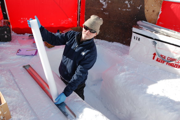 Andrew Smith, a senior principal research scientist at ANSTO, with one of the extracted ice cores.
