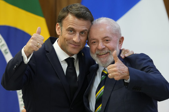 Brazilian President Luiz Inacio Lula da Silva, right, and France’s President Emmanuel Macron pose for photos at Planalto presidential palace in Brasilia.