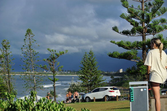 Locals at Alexandra Headland, on the Sunshine Coast, watching clouds from ex-tropical cyclone Alfred.