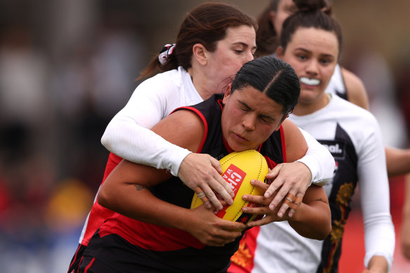 Madison Prespakis of the Bombers is challenged by Natalie Plane of the Saints.