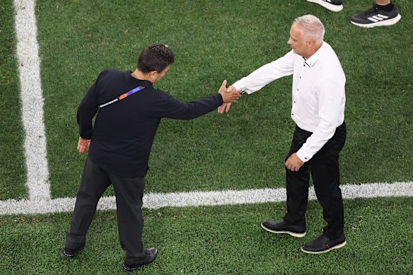 Iran head coach Amir Ghalehnoy shakes hands with his NZ counterpart Darren Bazeley.