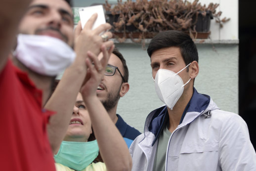Djokovic is mobbed by fans last month during his first public appearance since recovering from COVID-19.