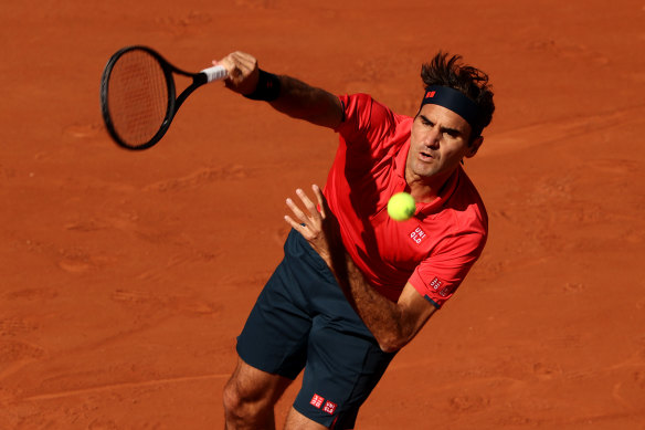 Roger Federer serves in his first-round match against Denis Istomin.