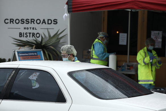 Medical staff at a pop-up COVID-19 testing clinic perform tests in the Sydney suburb of Casula.