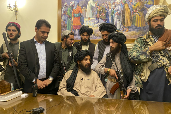 Taliban fighters take control of the Afghan presidential palace.