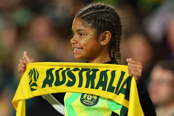 A young fan shows their support ahead of the clash.