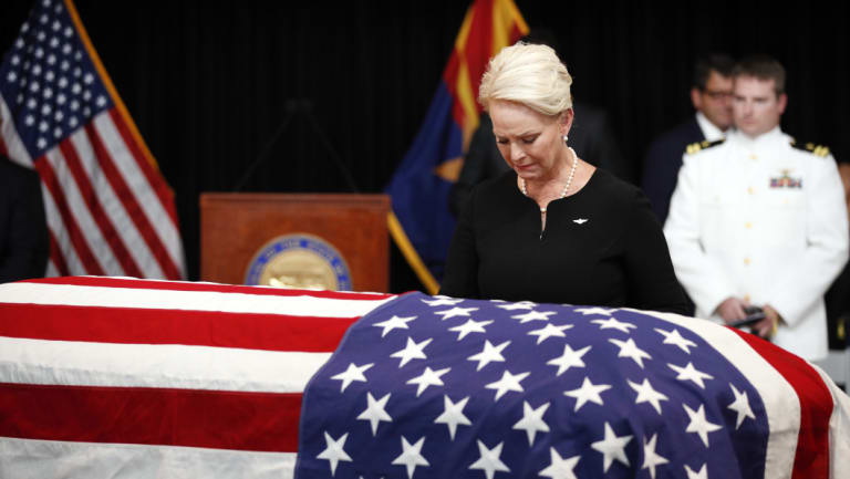 Cindy McCain, wife of, Senator John McCain, looks at the casket during a memorial service at the Arizona Capitol.