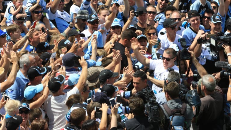 Flanagan and Paul Gallen are mobbed by fans after their 2016 NRL grand final victory.
