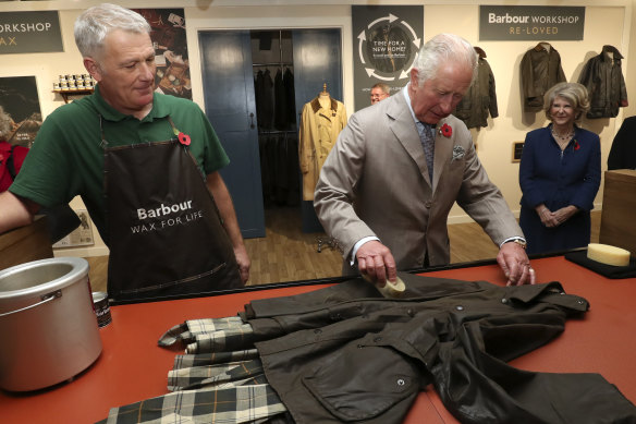 Then Prince Charles has a go at reproofing a jacket during a visit to Royal Warrant Holder, J Barbour And Sons in 2021.