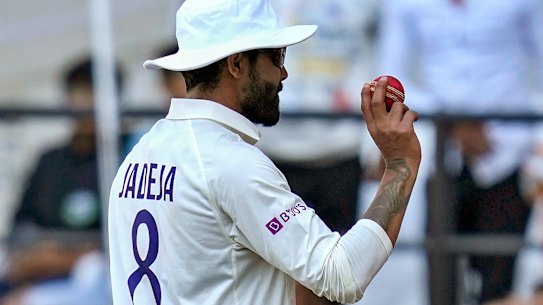 India’s Ravindra Jadeja holds up the ball after his five-wicket haul as he walks off the field during the first day of the first cricket test match.