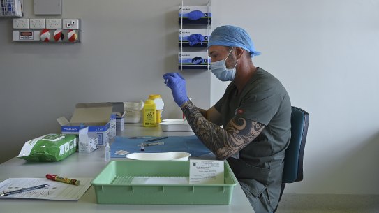 Pharmacist Blanko Radojkovic prepares a simulated vaccine at the Sydney Local Health District Vaccination Hub in Camperdown.