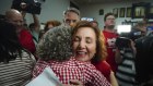 Jodie Belyea celebrates her byelection victory with a hug.