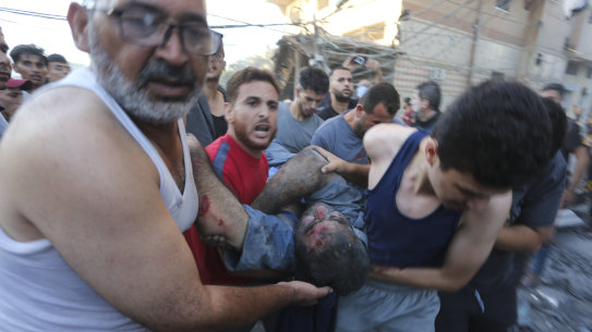 Palestinians evacuate survivors after an Israeli strike on the Gaza Strip.