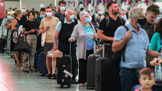Airline passengers wait in line to check in at Sydney’s Kingsford Smith domestic airport on Friday. 