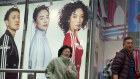 Shoppers walk by an apparel store in Shanghai.