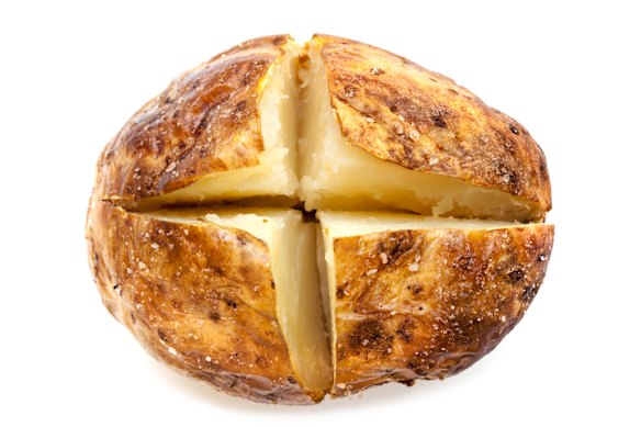 Once baked, score a cross into the hot potato.