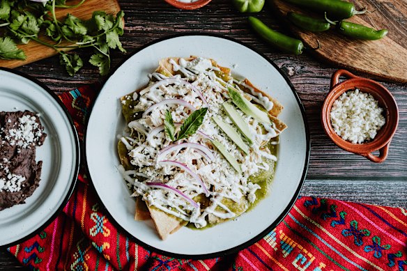 Chilaquiles verdes with chicken, avocado, onion, crema and feta. Black beans optional (pictured left).