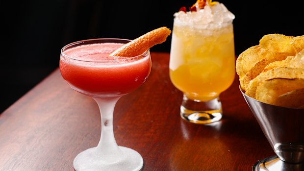 A Rhubarb Marg and Marigold Rush with a bowl of complimentary crisps.