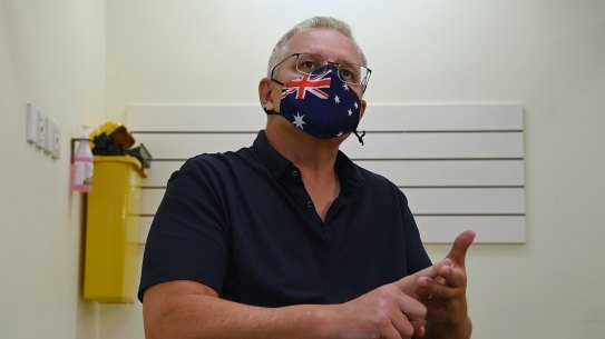    Prime Minister Scott Morrison receives his COVID-19 booster vaccine on Friday. 