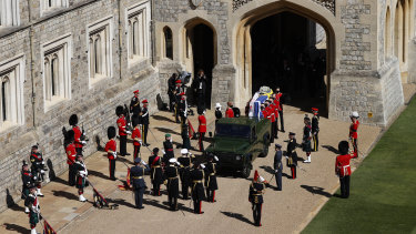 Members of the 1st Batallion Grenadier Guards place the coffin of Prince Philip onto a Land Rover outside Windsor Castle.