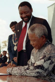 President Nelson Mandela signs the new constitution on December 10, 1996.