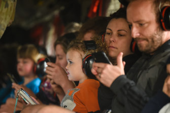 Families with small children onboard a Chinook helicopter are evacuated from Mallacoota.