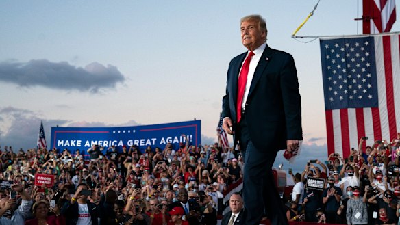 President Donald Trump arrives for a campaign rally at Orlando Sanford International Airport on Monday.