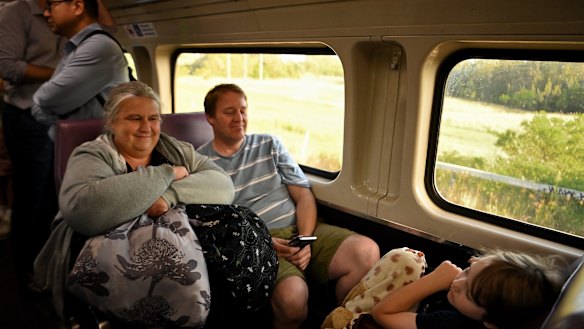 Crystal Parker (left) with her husband Ben Parker and their sleeping son Luke Parker (right) on the last V-set train.