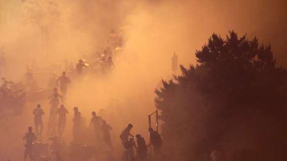 Lebanese riot police fire tear gas during a protest against government's plans to impose new taxes in Beirut, Lebanon.