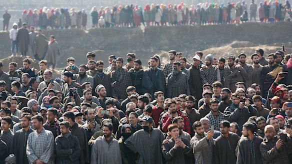 Kashmiri villagers gather to look at the wreckage of an Indian aircraft after it crashed in Budgam area on Wednesday.
